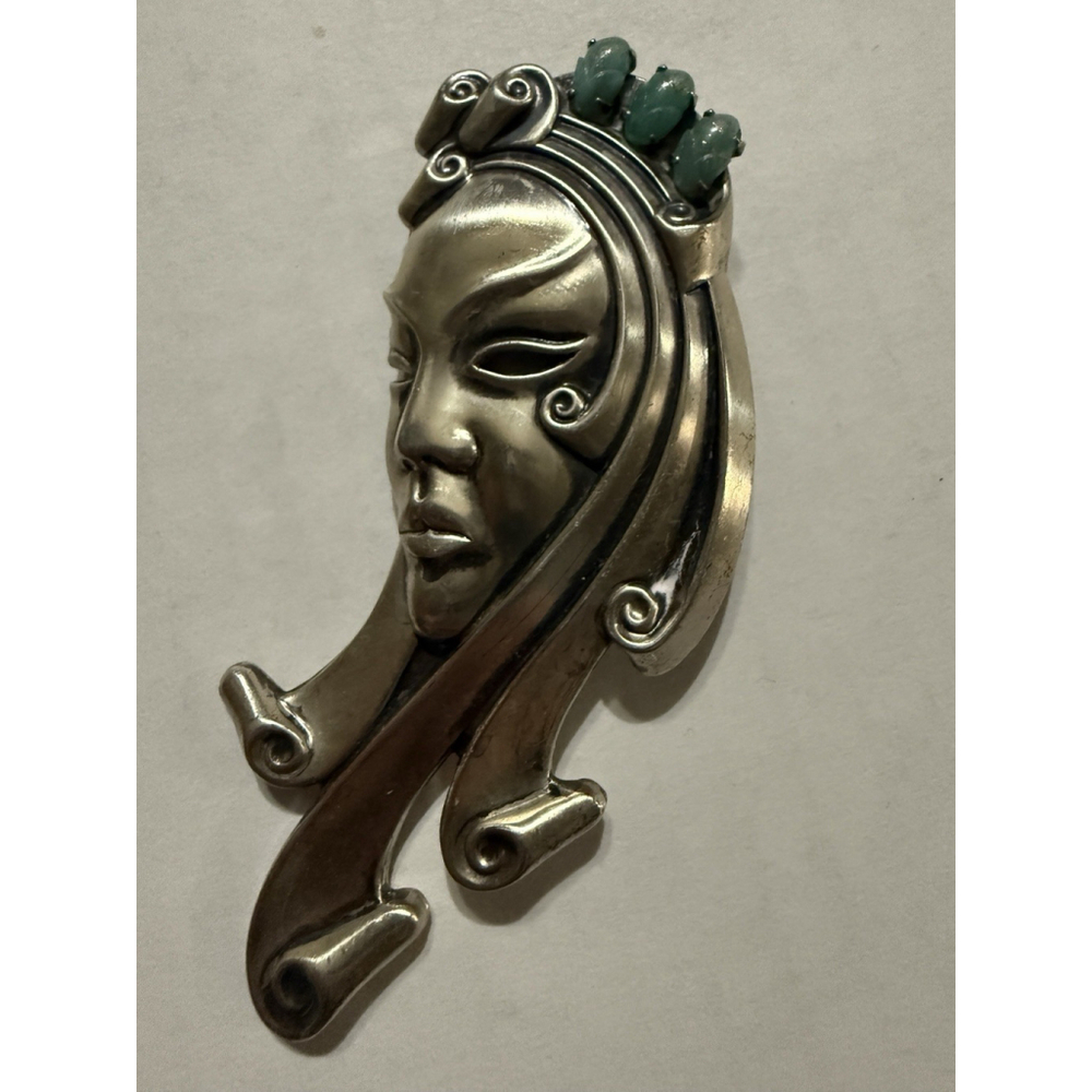 1940s Vintage sterling silver mask brooch with 3 oval green stones